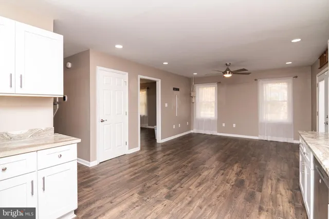 a view of a kitchen with a sink and dishwasher wooden floor