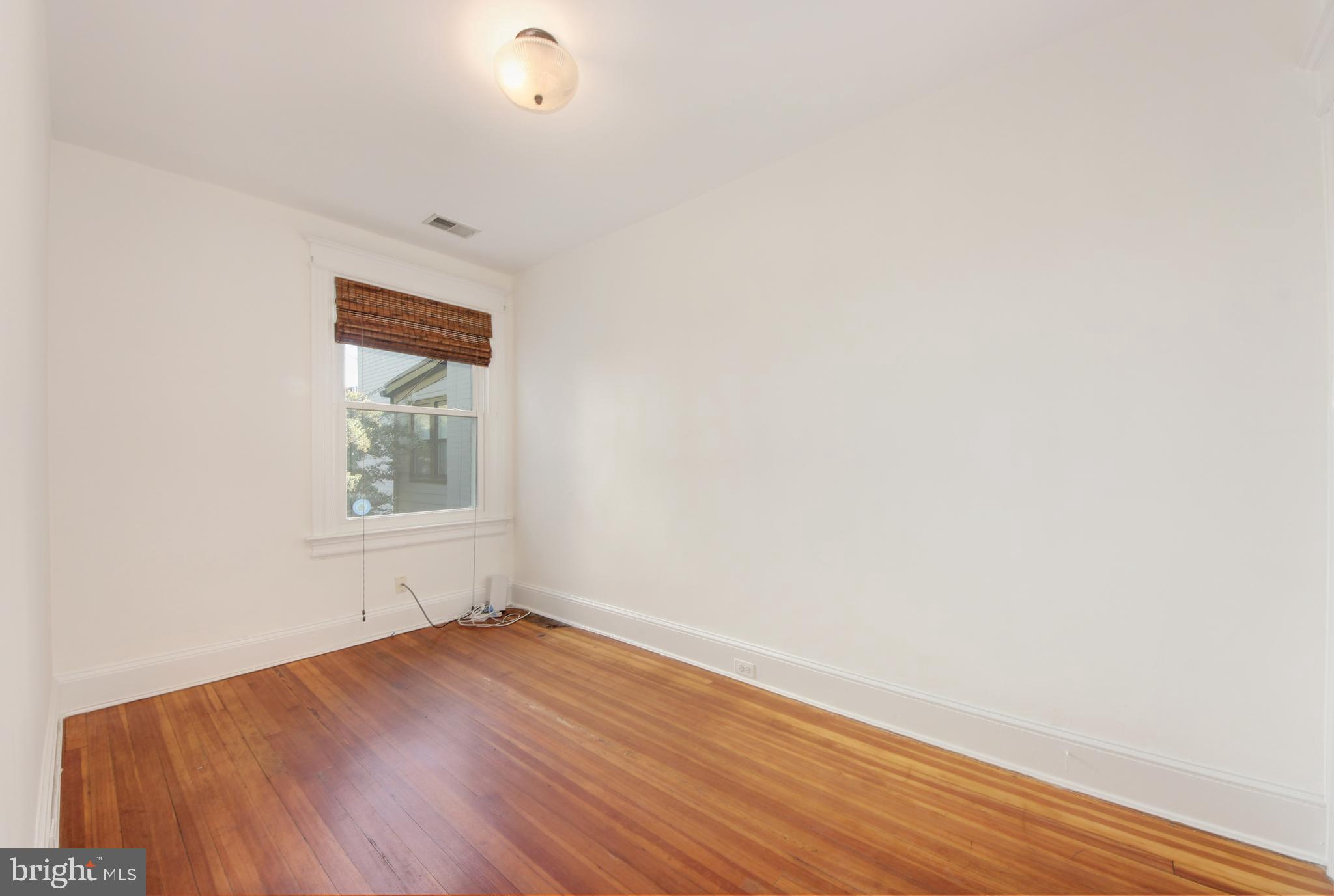 1321 Spring Road Northwest Washington, DC 20010 - Photo 12 of 30 a view of empty room with wooden floor and fan