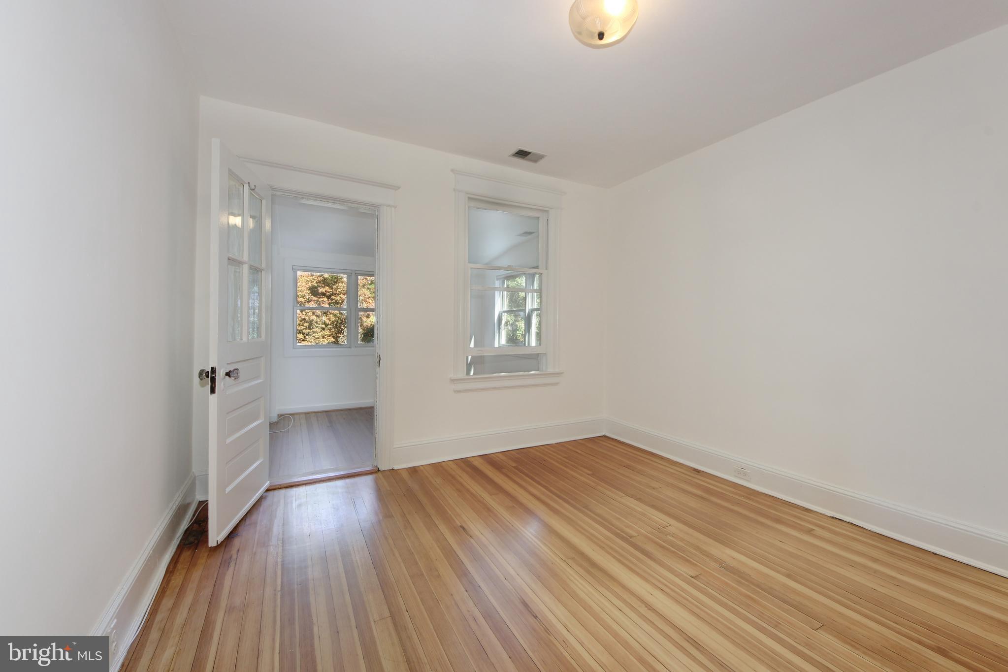 1321 Spring Road Northwest Washington, DC 20010 - Photo 16 of 30 wooden floor in an empty room with a window