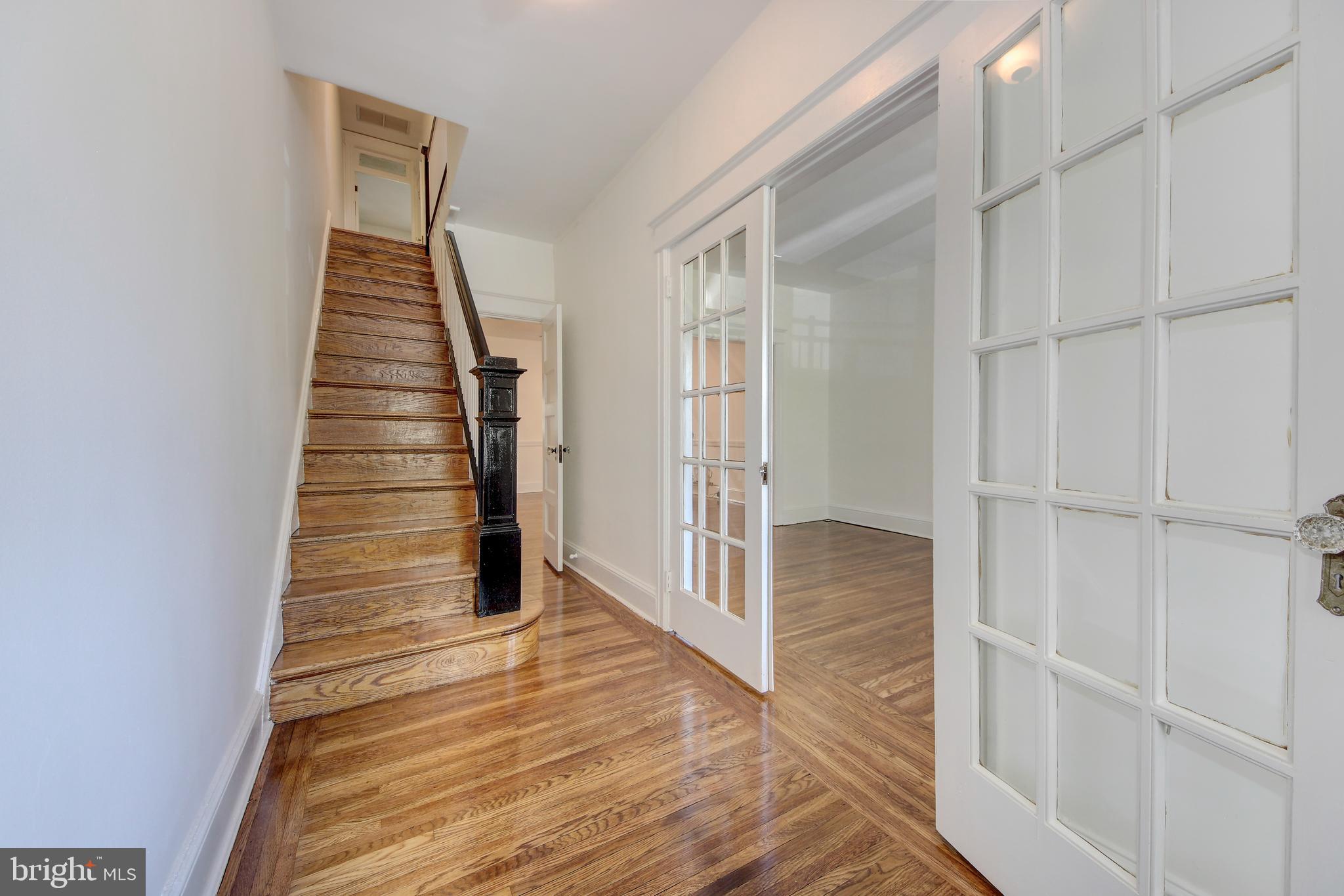 1321 Spring Road Northwest Washington, DC 20010 - Photo 3 of 30 a view of a hallway with wooden floor and entryway