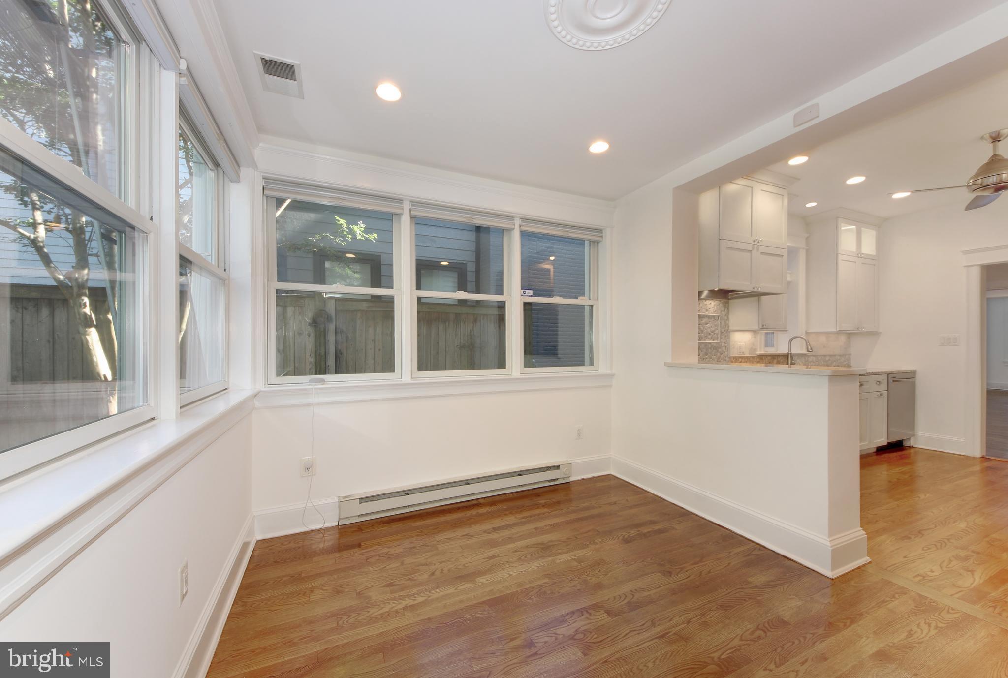 1321 Spring Road Northwest Washington, DC 20010 - Photo 10 of 30 a view of an empty room with wooden floor and a window