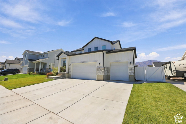 7939 Seattle Slew Road Eagle Mountain, UT 84005 - Photo 4 of 52 Two-story residence featuring white vertical siding and stone accents