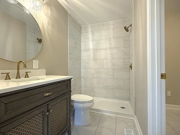 a view of an empty room with closet and mirror