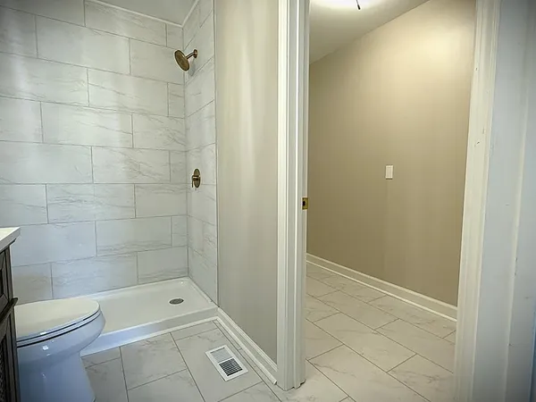 a bedroom with a large bed and a couch