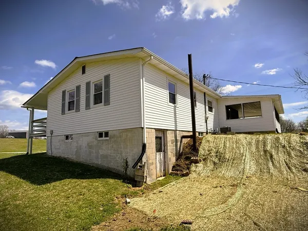 a view of a field with an ocean view