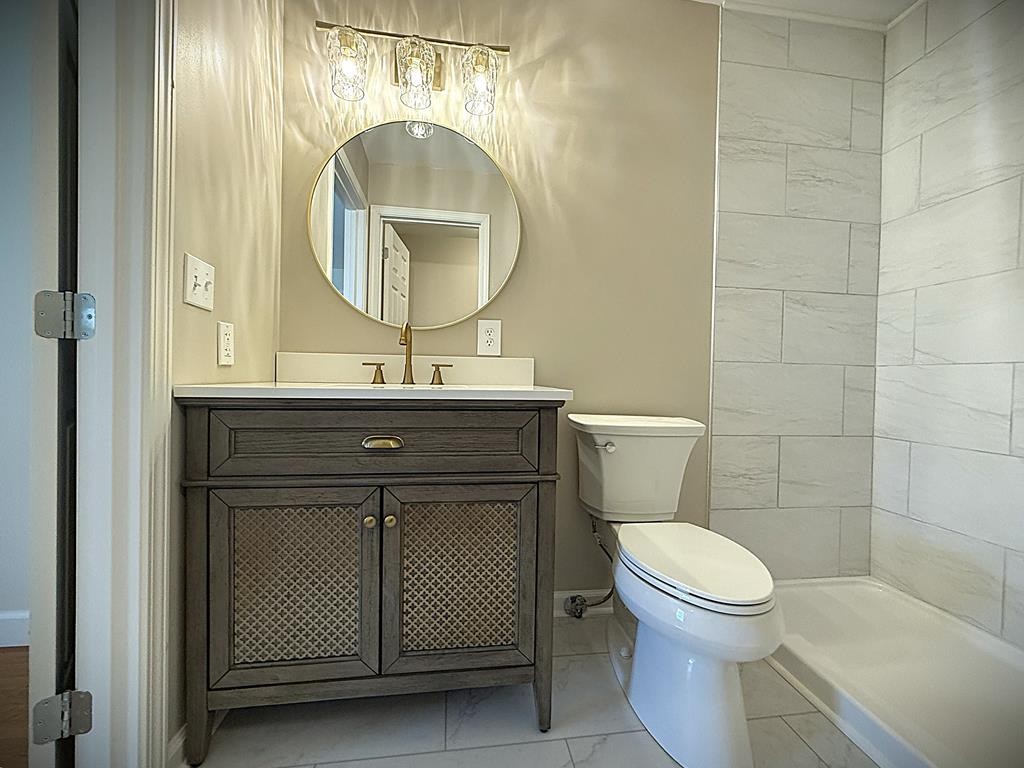 118 Collins Road Allons, TN 38541 - Photo 47 of 64 a bathroom with a toilet a sink and mirror