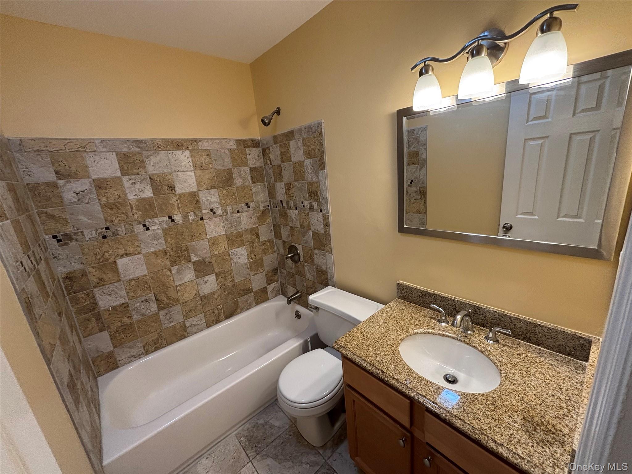 4 Colonial Road, Unit 92 Beacon, NY 12508 - Photo 7 of 9 a bathroom with a granite countertop sink toilet and shower