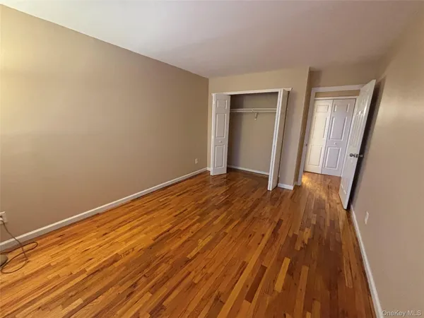 a view of a room with wooden floor and glass door