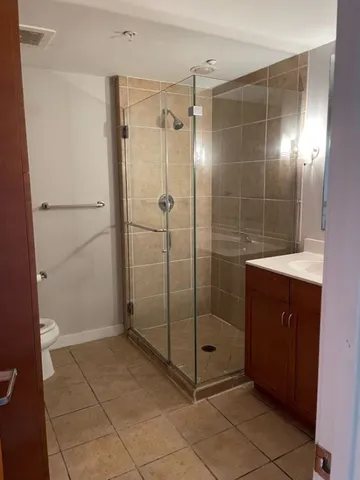 a bathroom with a shower and a sink