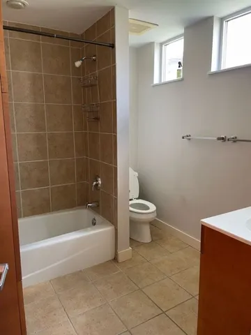 a white bath tub sitting next to a white toilet