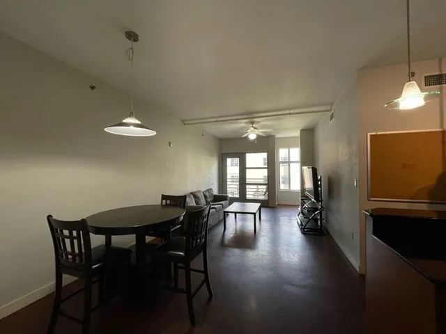 a view of a dining room with furniture and a chandelier