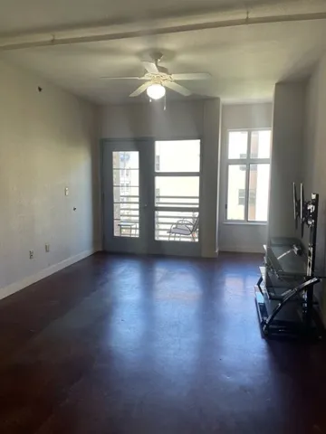 a view of a livingroom with hardwood floor and a window