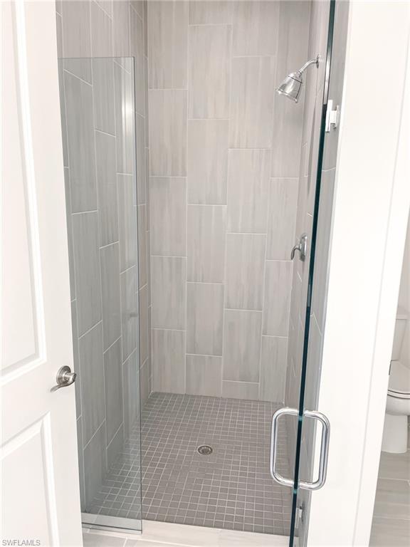 14684 Kingfisher Loop Naples, FL 34120 - Photo 11 of 18 a bathroom with a shower