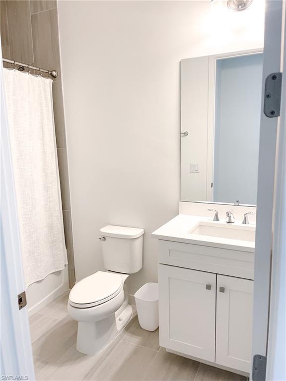 14684 Kingfisher Loop Naples, FL 34120 - Photo 13 of 18 a bathroom with a sink toilet and shower