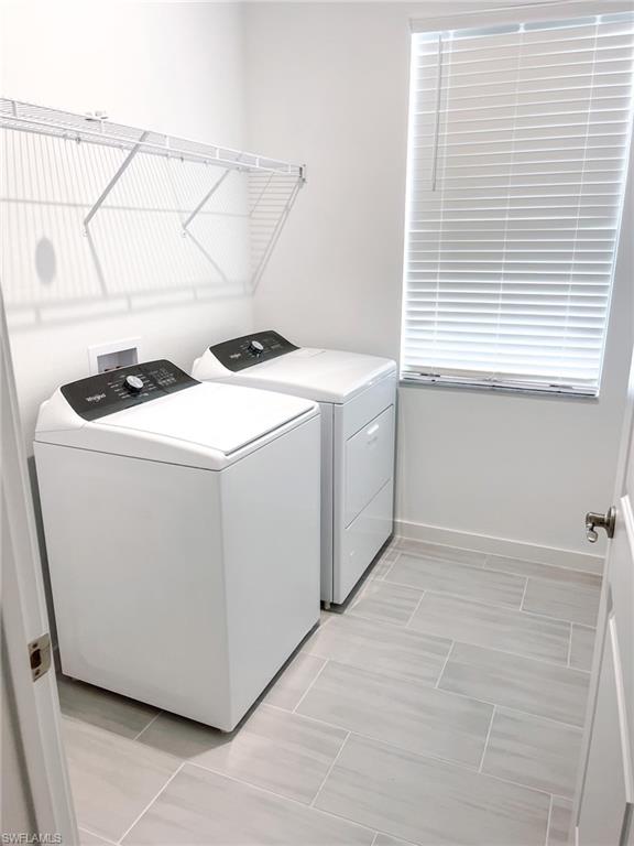 14684 Kingfisher Loop Naples, FL 34120 - Photo 16 of 18 a utility room with dryer and washer