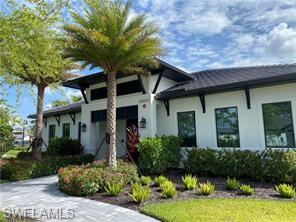 14684 Kingfisher Loop Naples, FL 34120 - Photo 17 of 18 a front view of a house with a yard