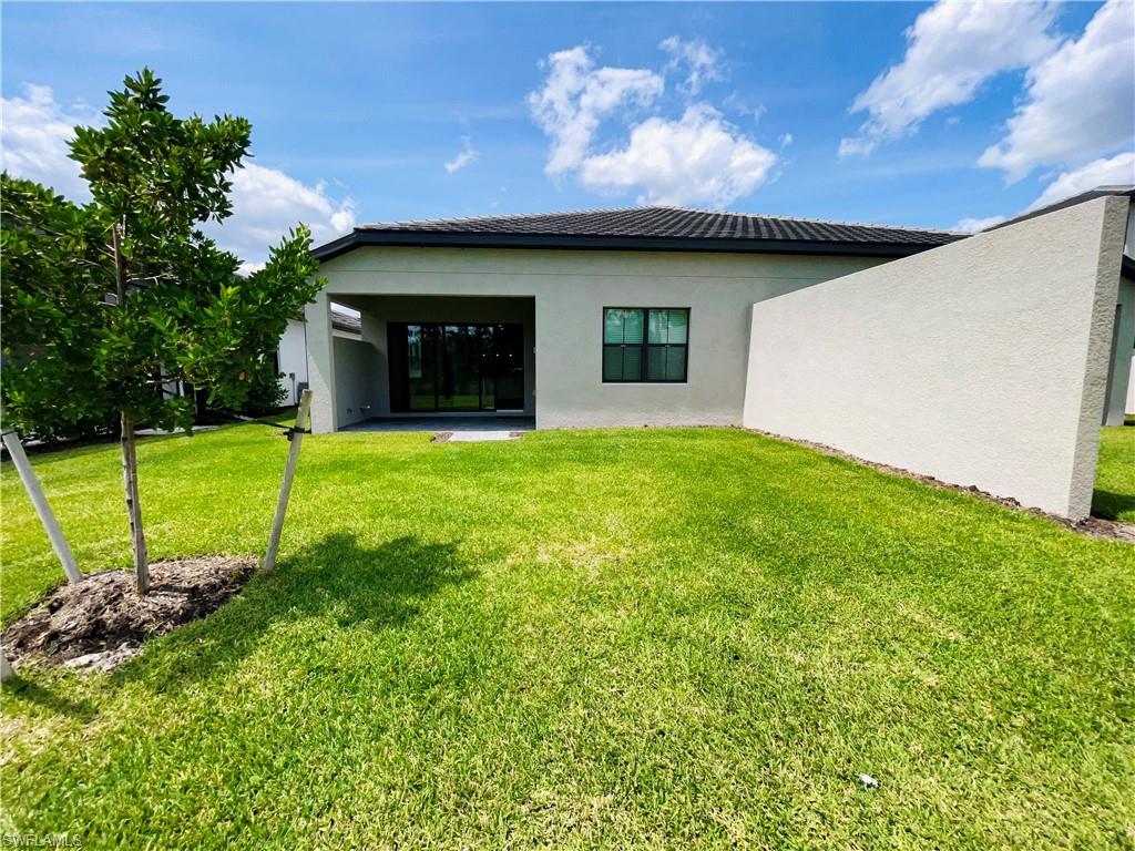 14684 Kingfisher Loop Naples, FL 34120 - Photo 2 of 18 a view of a house with a backyard