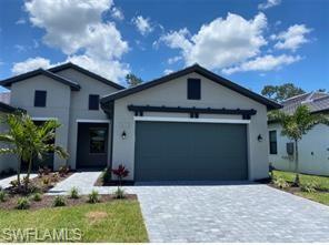 14684 Kingfisher Loop Naples, FL 34120 - Photo 4 of 18 a front view of a house with garage
