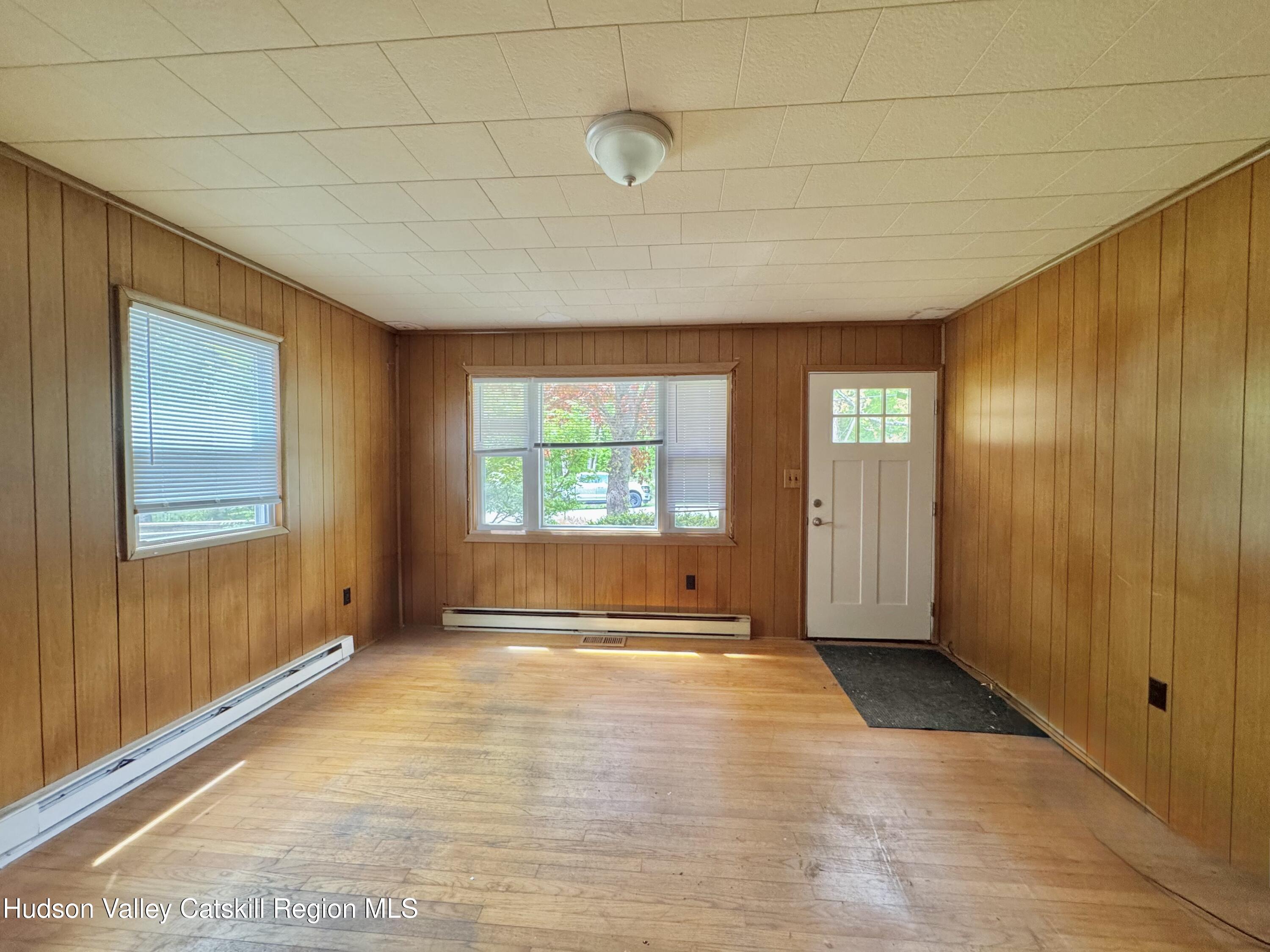 752 Old Rte 23 Acra, NY 12405 - Photo 11 of 25 a view of an empty room with wooden floor and a window