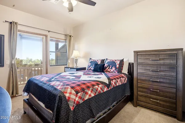 a bed sitting in a bedroom next to a window