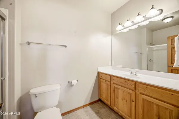 a bedroom with a bed and a mirror
