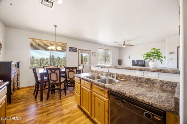 a kitchen with granite countertop sink table and chairs