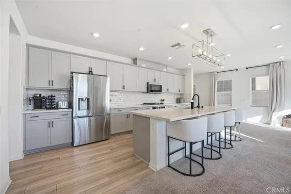 a kitchen with refrigerator a sink and cabinets