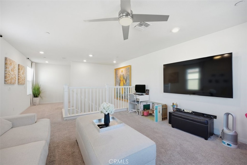 7608 Citrusmoon Court Riverside, CA 92507 - Photo 11 of 25 a living room with furniture and a flat screen tv