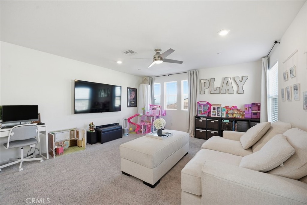7608 Citrusmoon Court Riverside, CA 92507 - Photo 12 of 25 a living room with furniture and a flat screen tv