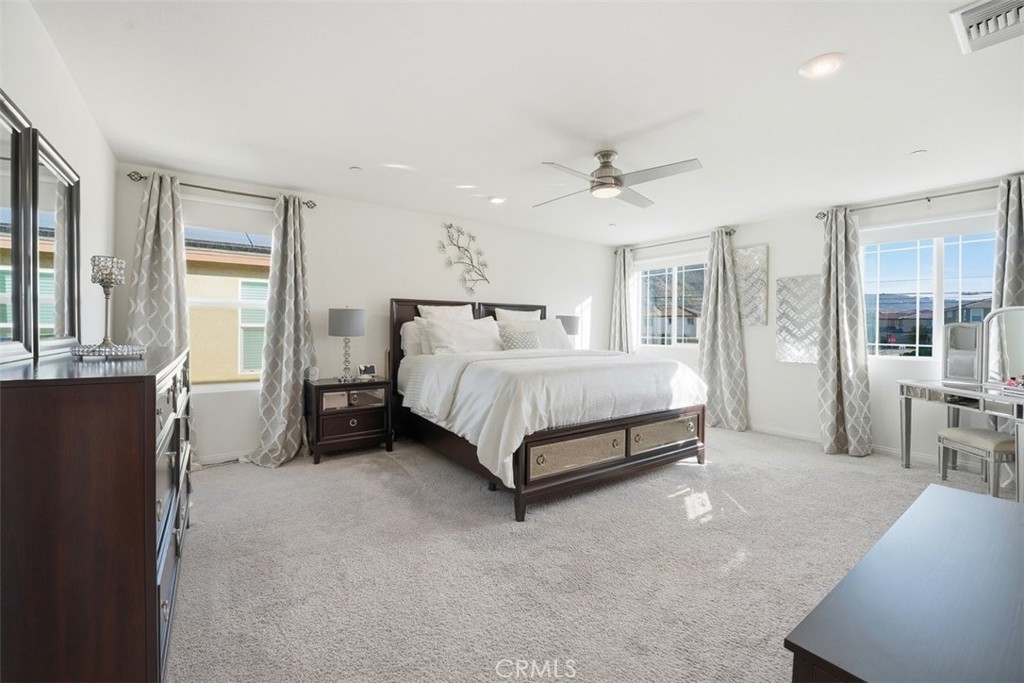 7608 Citrusmoon Court Riverside, CA 92507 - Photo 13 of 25 a bedroom with a bed a table and painting