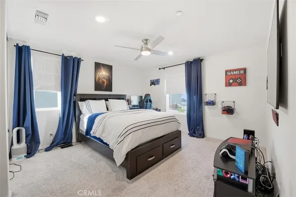 a spacious bedroom with a bed and a walk in closet