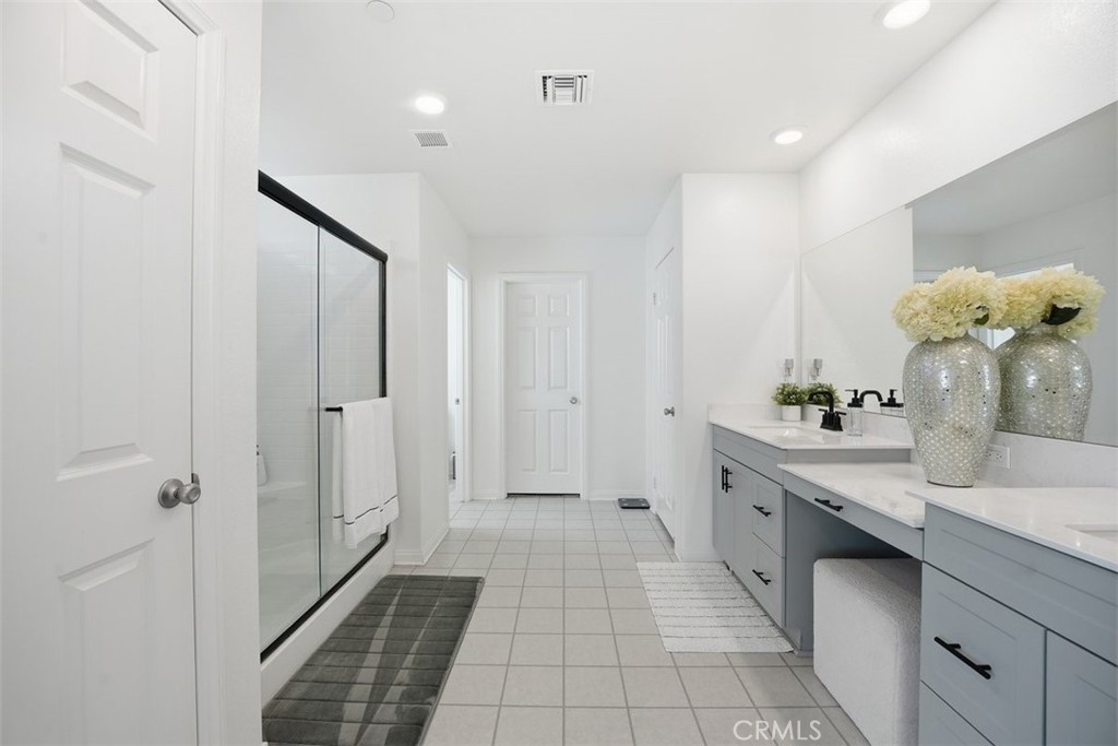 7608 Citrusmoon Court Riverside, CA 92507 - Photo 18 of 25 Primary bathroom: Dual sinks, built-in make-up vanity. Plenty of storage and huge walk-in closet at end of bath.