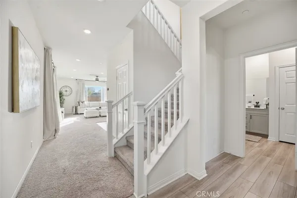 a view of a hallway with wooden floor and entryway