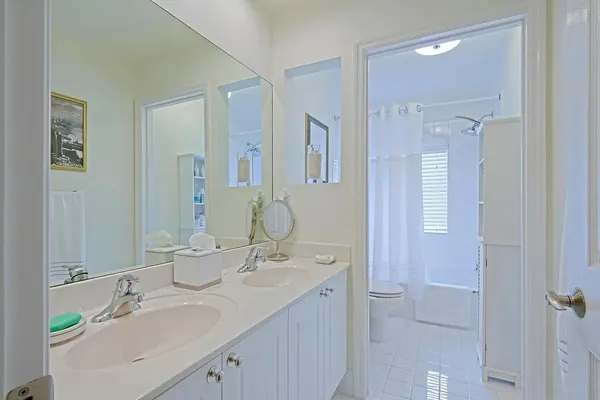 a bathroom with a double vanity sink mirror and double