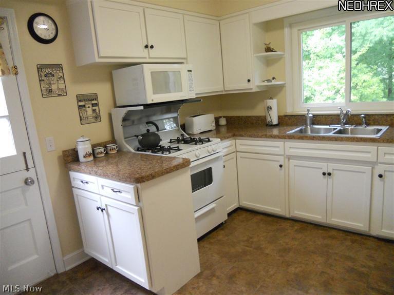 1910 Temblethurst Road South Euclid, OH 44121 - Photo 4 of 13 Updated Kitchen with White Cabinets, Special Built-ins, & All Appliances Stay