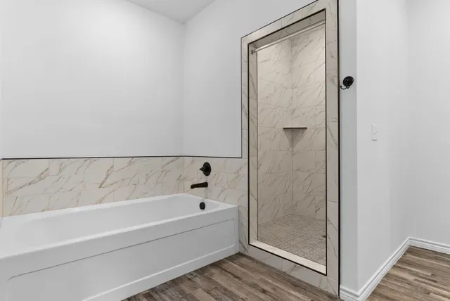 a bathroom with a bathtub and shower