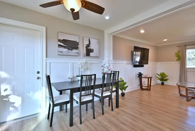 a view of a dining room with furniture and wooden floor