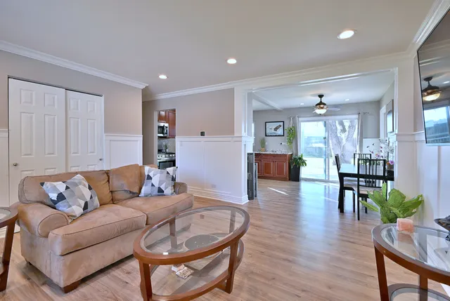 a living room with furniture and wooden floor