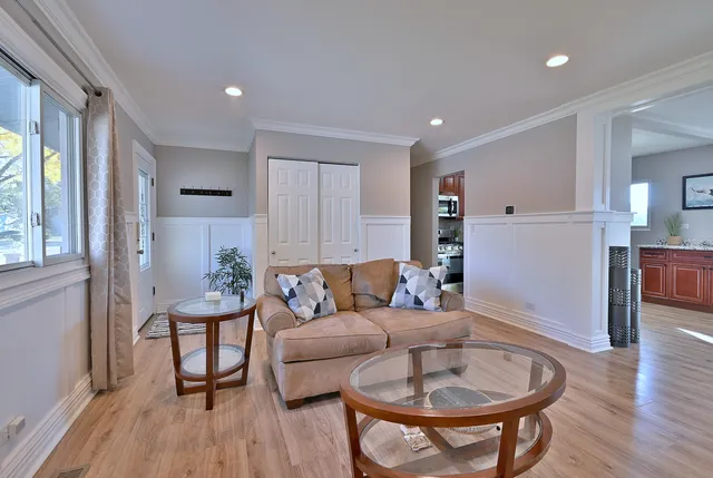 a living room with furniture and a wooden floor