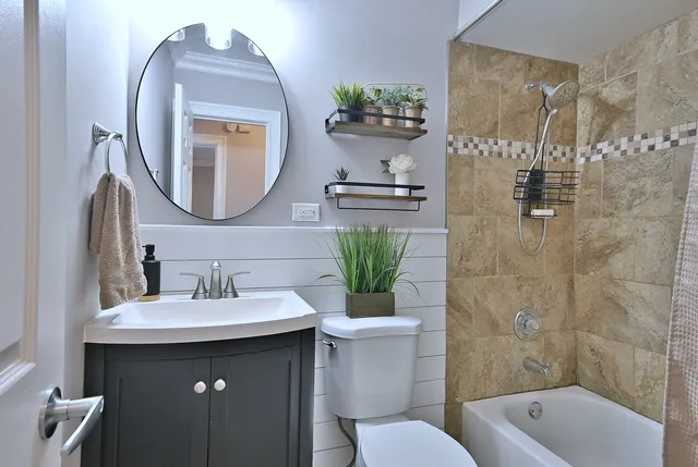 a bathroom with a sink mirror and toilet