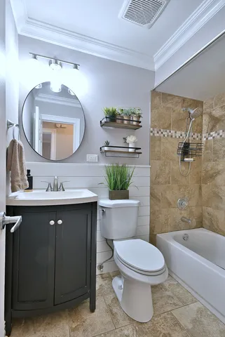 a bathroom with a toilet a sink and bathtub