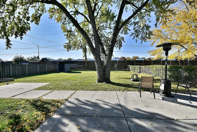 a view of a yard with wooden fence