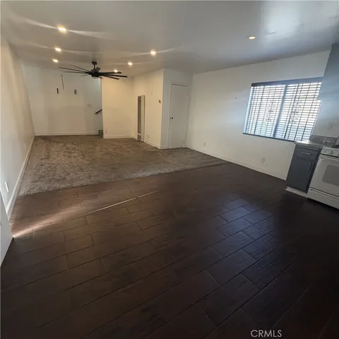 a living room with furniture and a ceiling fan