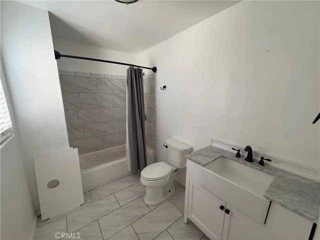 a bathroom with a sink toilet a mirror and shower