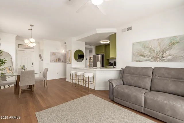 a living room with furniture and view of kitchen