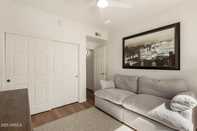 a living room with furniture and a painting