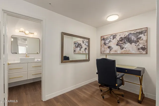 a view of a workspace with furniture and a bathroom