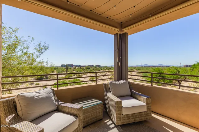 a view of a roof deck with couches and potted plants
