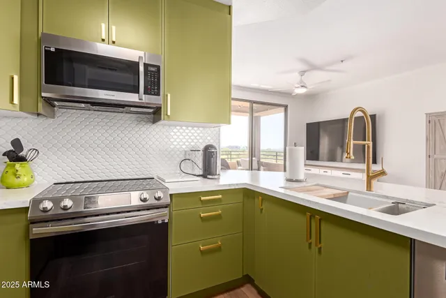a kitchen with a sink and a stove top oven