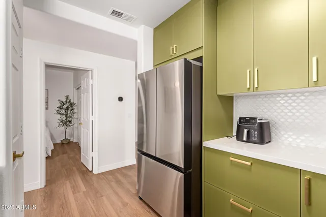 a kitchen with a refrigerator and a sink